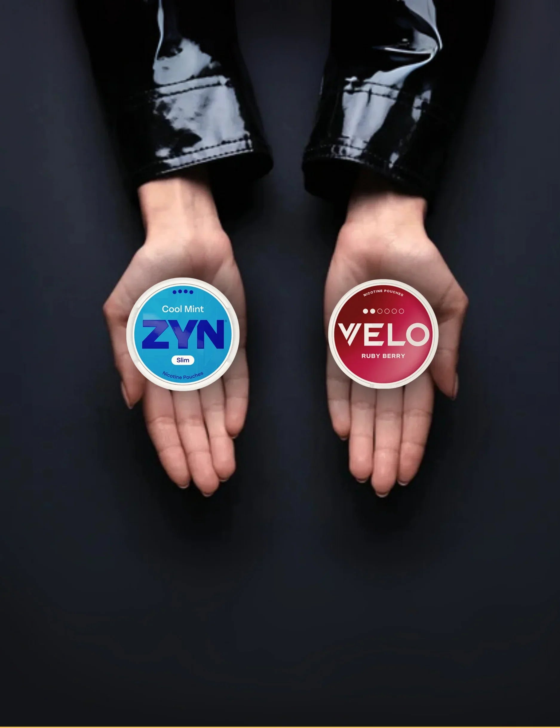 Two hands holding a one can of nicotine pouches in each hand