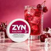 ZYN black cherry 3mg next to ice and cherries and a cherry drink